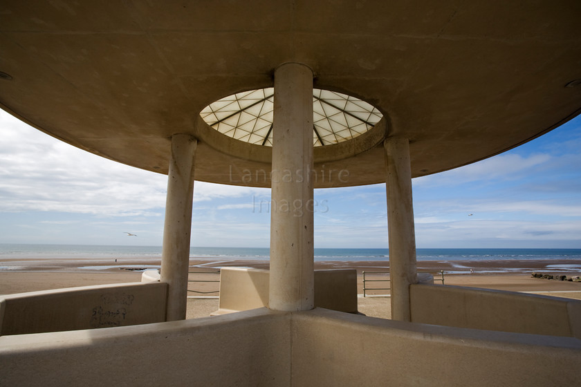 DCP1740 
 Shelter on the promenade at Cleveleys, Lancashire 
 Keywords: Cleveleys, Lancashire, Lancs, North West, northwest, England, UK, Britain, Europe, Fylde, coast, seafront, seawall, cloud, blue, sky, prom, promenade, shelter, round, roof, symetry, symmetry, shape, pattern, concrete, modern, architecture, design, DCP1740