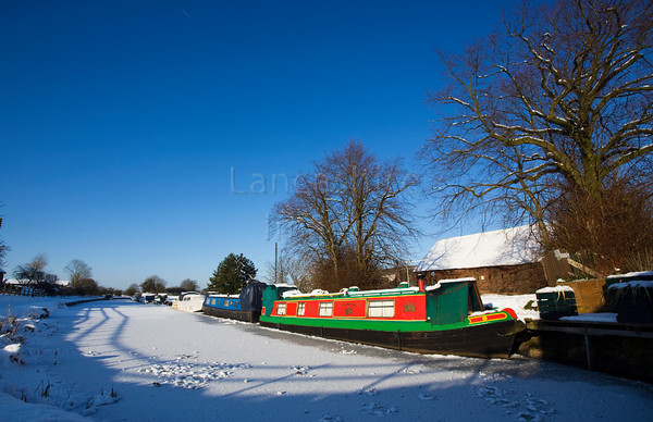 DCP1716 
 Narrow boats on frozen Leeds and Liverpool canal at Adlington 
 Keywords: Adlington, Leeds and Liverpool, Canal, waterway, season, winter, snow, cold, ice, freeze, frozen, tow, path, towpath, narrow, boat, boats, barge, barges, transport, transportation, tree, moored, tow, path, towpath, shadow, shadows, blue, sky, wideangle, Lancashire, Lancs, Northwest, North, West, England, UK, Britain, Europe, DCP1716