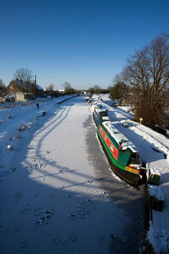 DCP1717 
 Narrow boats on frozen Leeds and Liverpool canal at Adlington 
 Keywords: Adlington, Leeds and Liverpool, Canal, waterway, season, winter, snow, cold, ice, freeze, frozen, tow, path, towpath, narrow, boat, boats, barge, barges, transport, transportation, tree, moored, tow, path, towpath, shadow, shadows, blue, sky, wideangle, Lancashire, Lancs, Northwest, North, West, England, UK, Britain, Europe, DCP1717