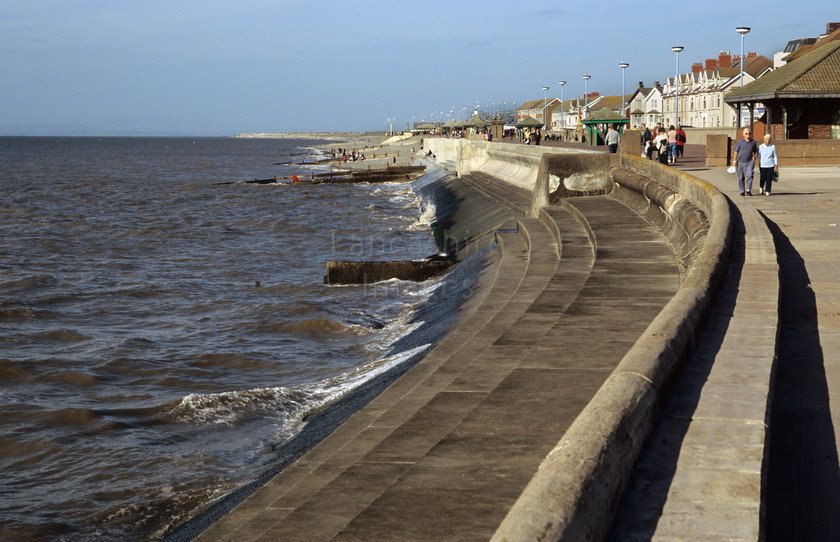 DCP0498 
 The promenade (prior to rebuilding) and sea wall at Cleveleys in Lancashire 
 Keywords: Lancashire Lancs North West Northwest England Britain UK Europe Cleveleys Fylde Coast Seaside Resort Holiday Sea Wall prom promenade wave North Sea barrage protect protection walk amble leisure stroll sea air concrete curve exposed blue sky horizontal DCP0498