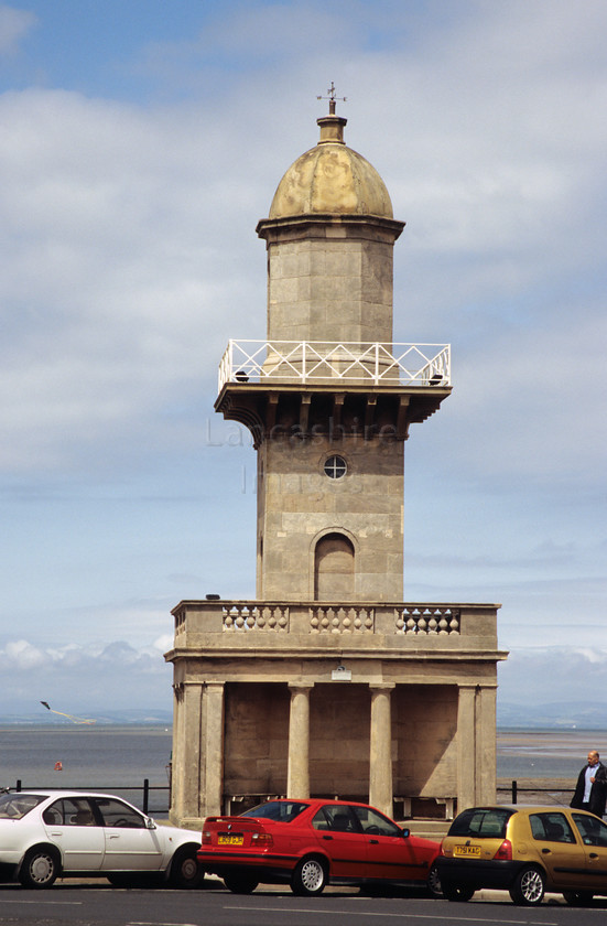 DCP0570 
 Lower lighthouse on the promenade at Fleetwood 
 Keywords: Lancashire, Lancs, North, West, Northwest, England, UK, Britain, Europe, Fleetwood, Town, Centre, Fylde, Coast, Seaside, Resort, lower, lighthouse, light, house, prom, promeande, transport, road, car, carpark, parked, park, architecture, building, disused, kite, fly, flying, person, people, short, small, vertical