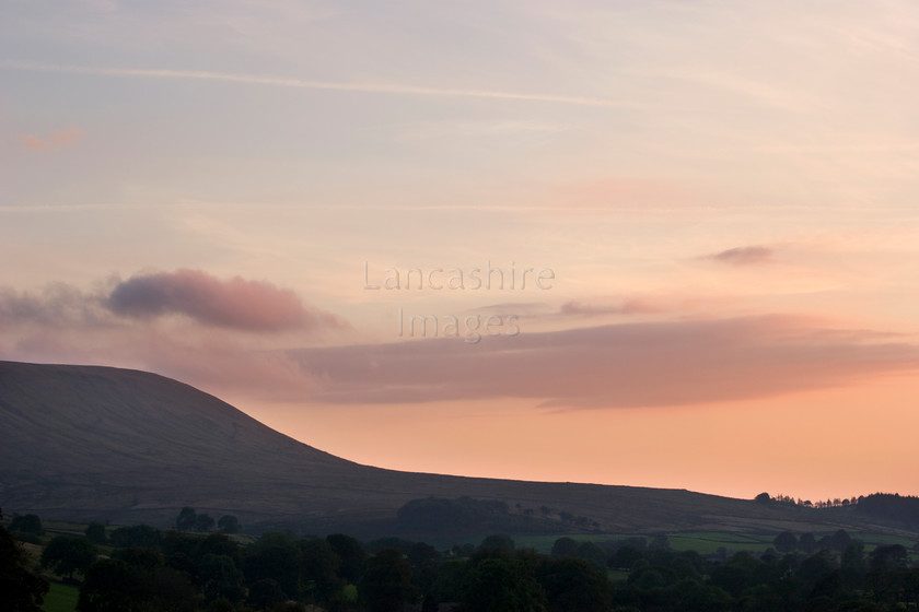 DCP1265 
 Sunset and the silhouette of Pendle Hill in Lancashire 
 Keywords: Pendle, Hill, Sunset, Evening, Mountain, Silhouette, Landmark, Lancashire, Lancs, North, West, Northwest, England, UK, Britain, Ribble, Valley, cloud, red, orange, colour, color, sky, side, flank, tree, frame, framed, shape, curve, curving, folklore, witch, witches, magic, Europe, horizontal, DCP1265