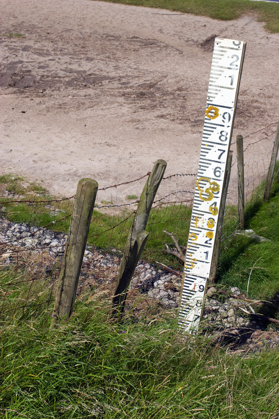 DCP1186 
 Depth measuring stick on the Pilling embankment on the Wyre coast. The embankment was built to protect the surrounding farm land from flood by the sea. 
 Keywords: Pilling, Lancashire, Lancs, North, West, Northwest, England, UK, Britain, Europe, embankment, bank, measure, measuring, stick, guage, height, depth, dry, vertical, DCP1186