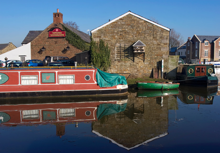 DCP1318 
 ThOwd Tithe Barn pub by the Lancaster Canal in Garstang 
 Keywords: Garstang; Lancaster; Canal; Lancashire; Lancs; North; West; Northwest; England; UK; Britain; Europe; waterway; narrow; boat; pub; pigeon; loft; reflect; reflection; Tithe; barn; transport; transportation; water; blue; sky; horizontal DCP1318