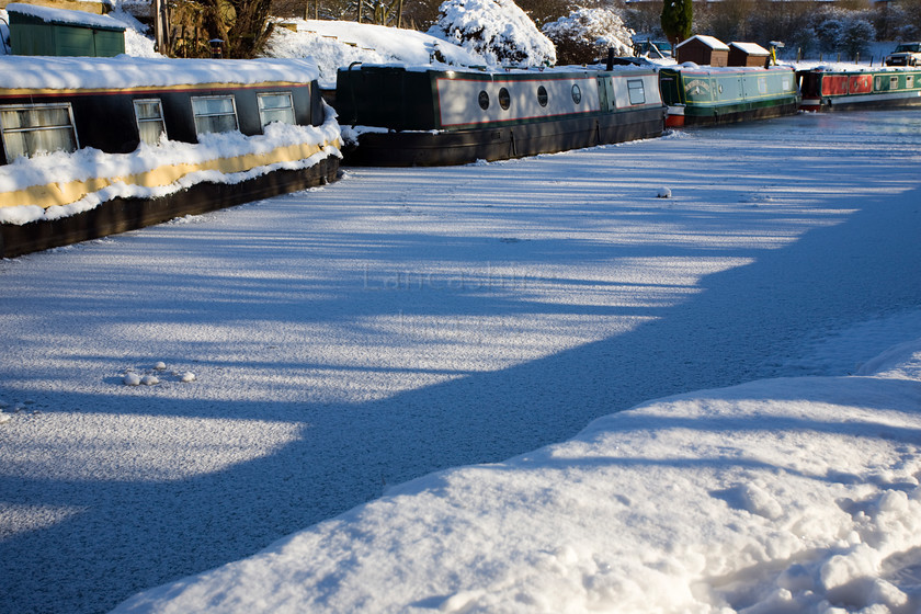 DCP1714 
 Narrow boats on frozen Leeds and Liverpool Canal at Adlington 
 Keywords: Adlington, Leeds and Liverpool, Canal, waterway, season, winter, snow, cold, ice, freeze, frozen, tow, path, towpath, narrow, boat, boats, barge, barges, transport, transportation, tree, moored, shadow, shadows, blue, sky, Lancashire, Lancs, Northwest, North, West, England, UK, Britain, Europe, DCP1714